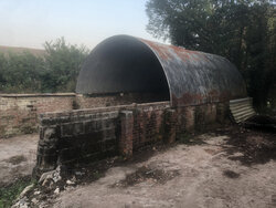 The hut partially dismantled in the farmyard.